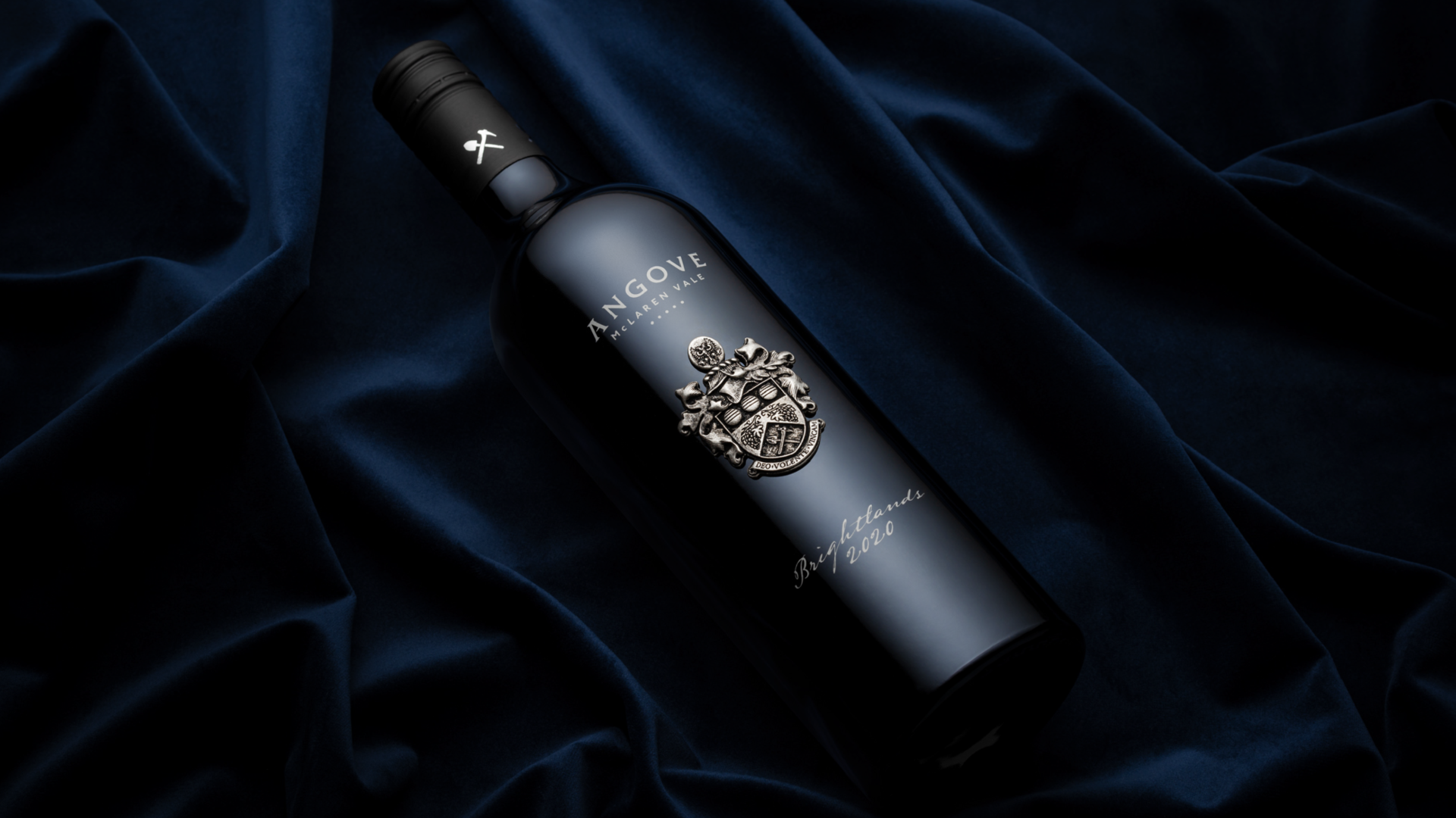 Full bottle of Angove Brightlands Shiraz on blue velvet background