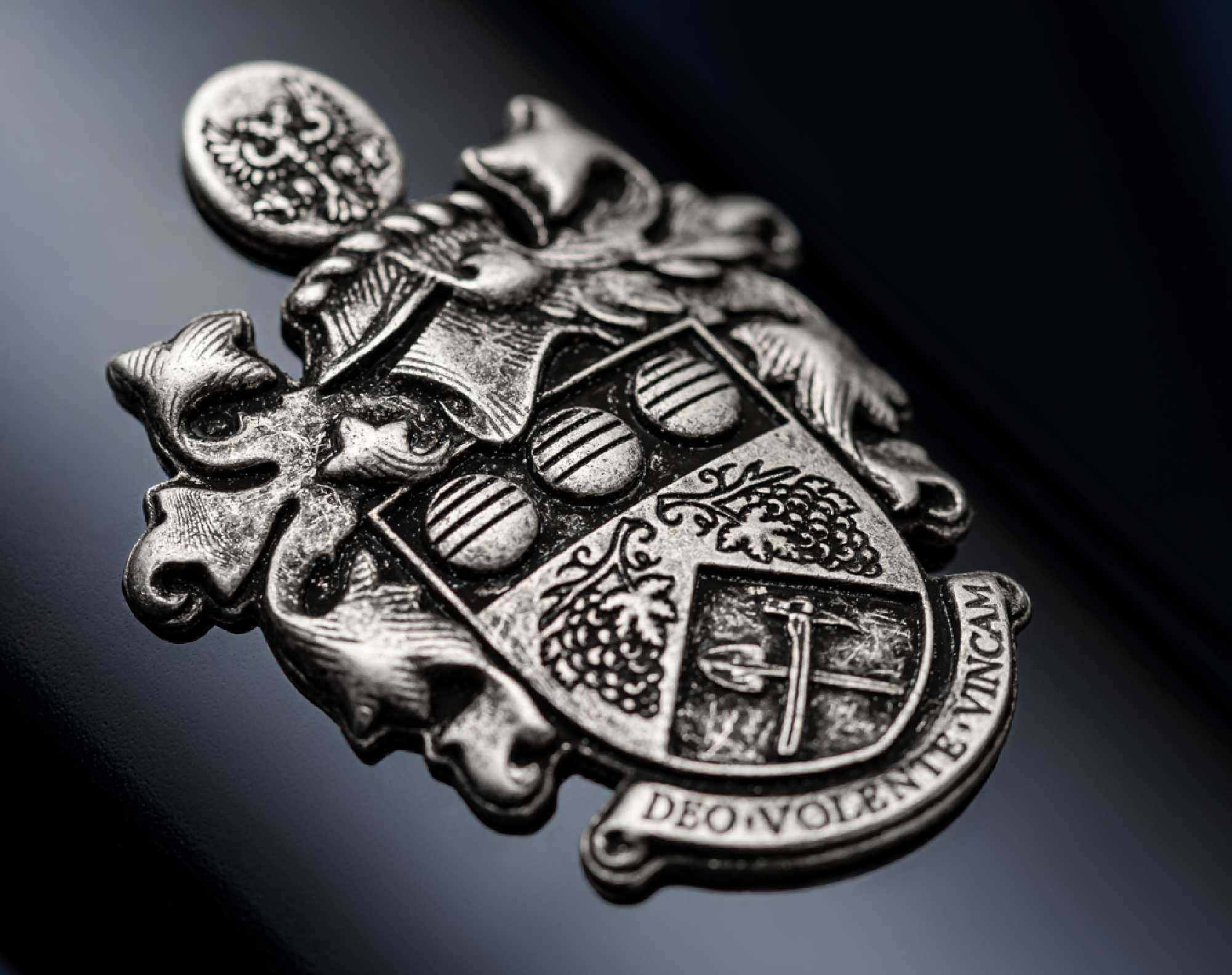 Close up of Angove Family Winemakers family crest cast in metal