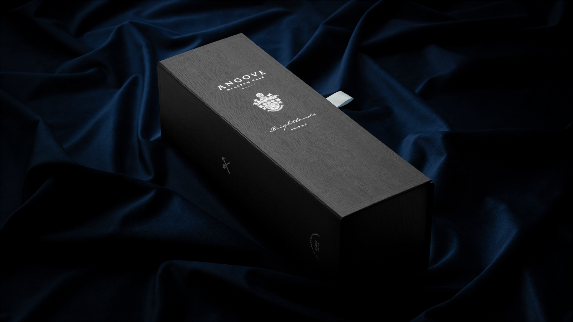 Gift box for Angove Brightlands Shiraz featuring silver foil and presented on a blue velvet background