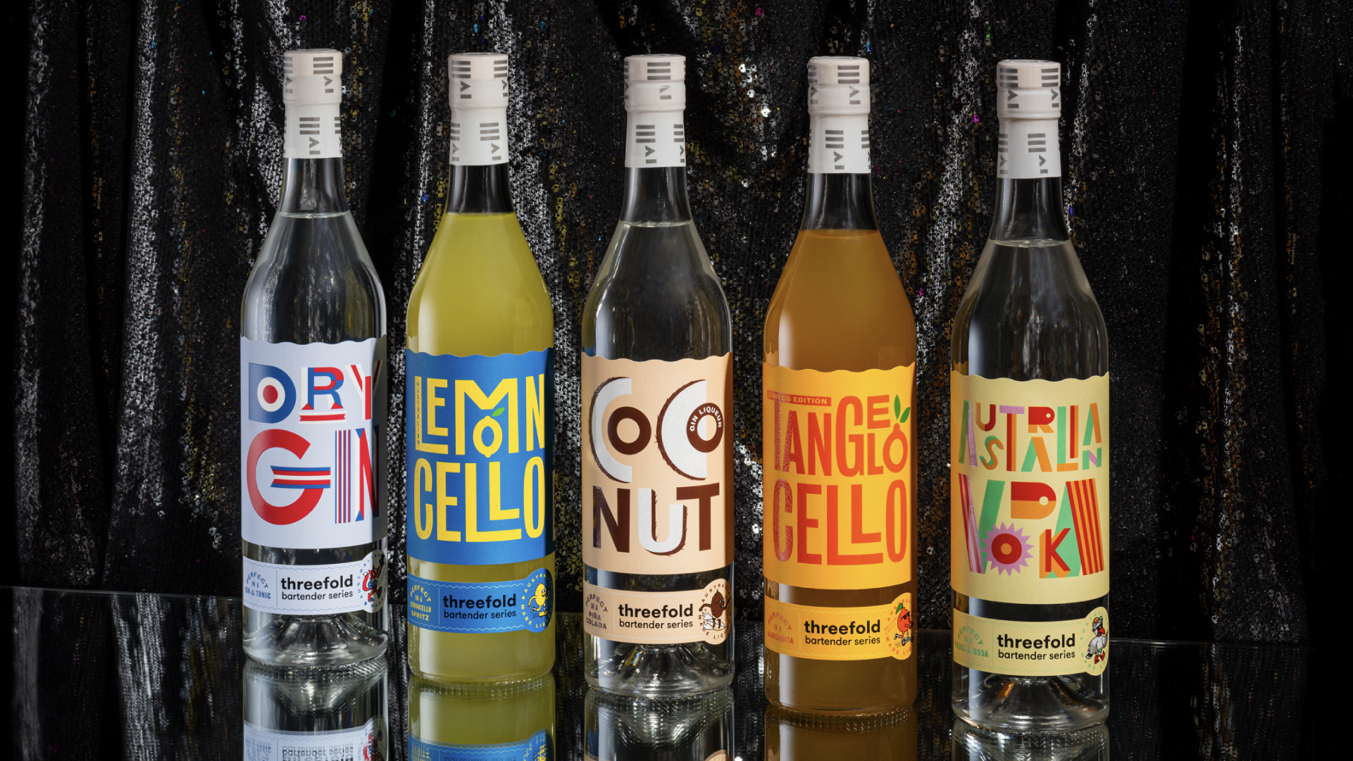 A line up of the Threefold Bartender's series gin bottles showcasing colourful 2 piece label packaging design. The line up features Dry Gin, Lemoncello, Coconut, Tangelocello and Australian Vodka.