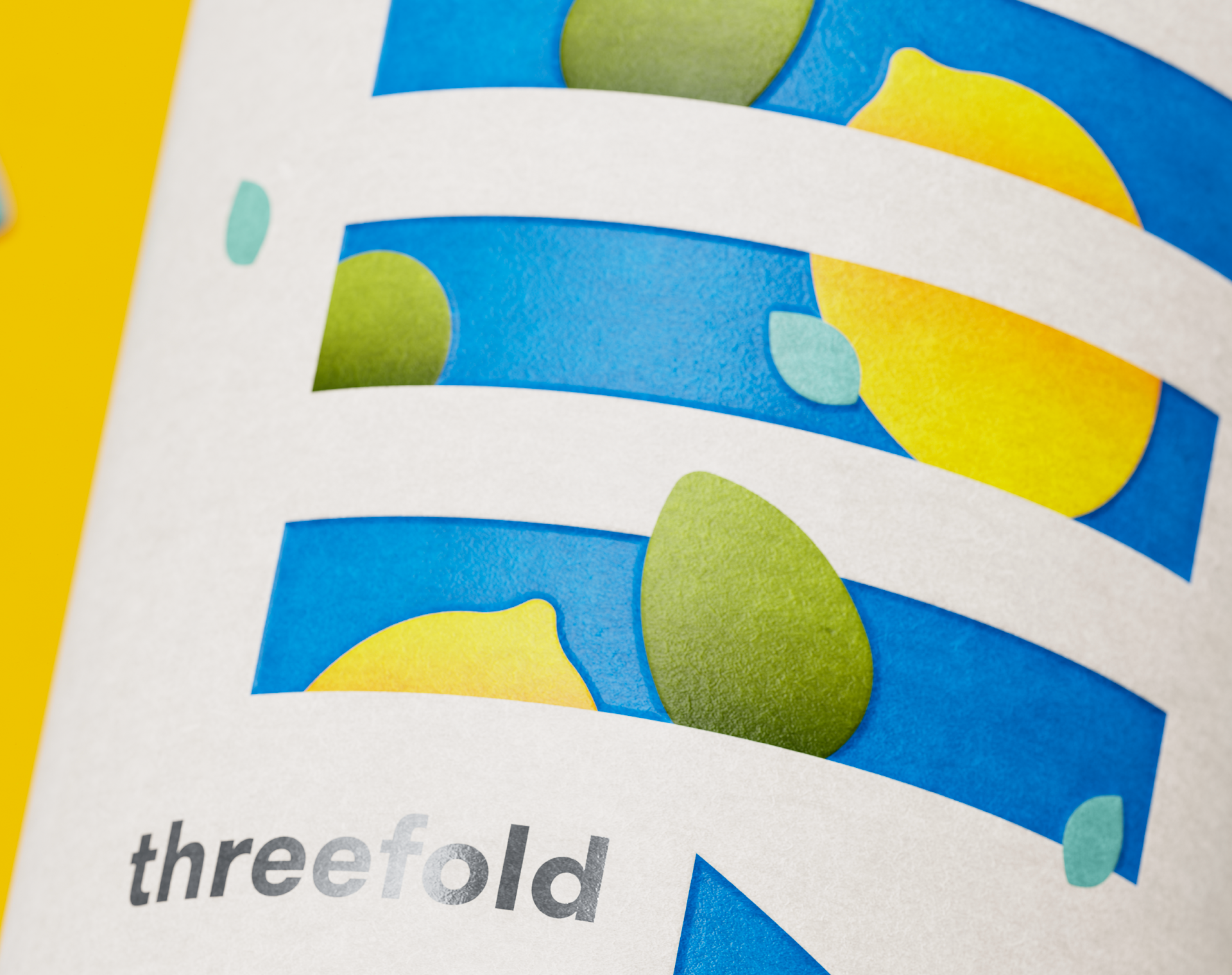 A close-up photograph of the Threefold Mediterranean gin label design featuring a deboss effect and gun-metal foil.