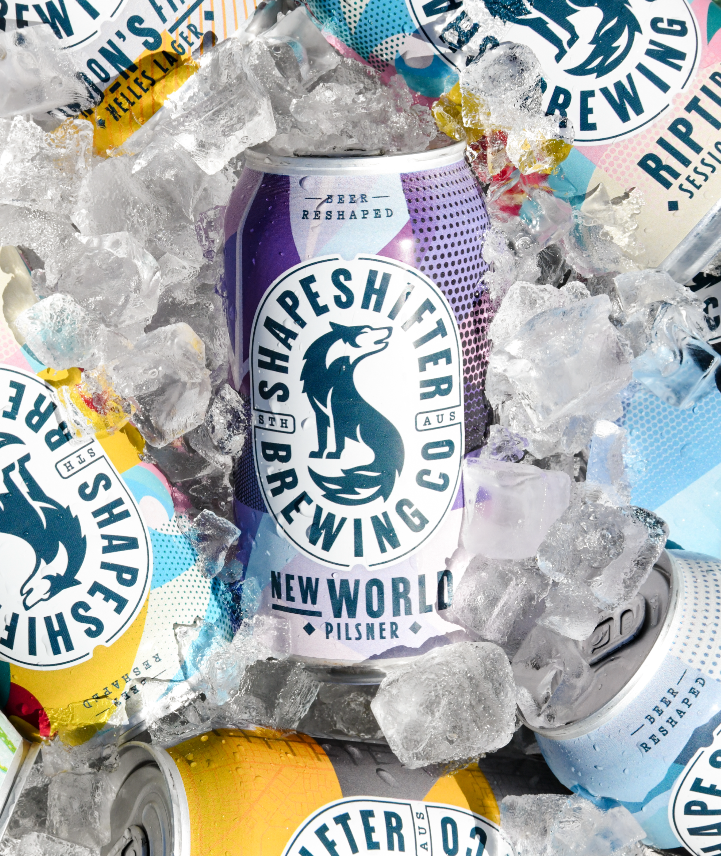 Many cans of colourful craft beer in an esky covered with ice. Each can features the logo of a shapeshifting wolf.