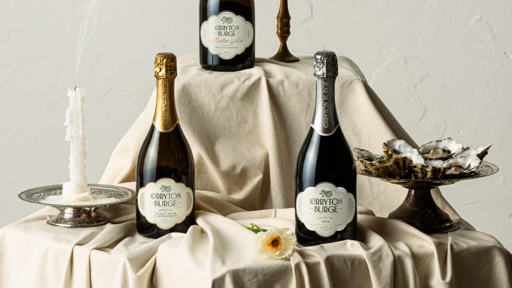 Hero image showing the range of three Corryton Burge sparkling wines on a styled table setting.