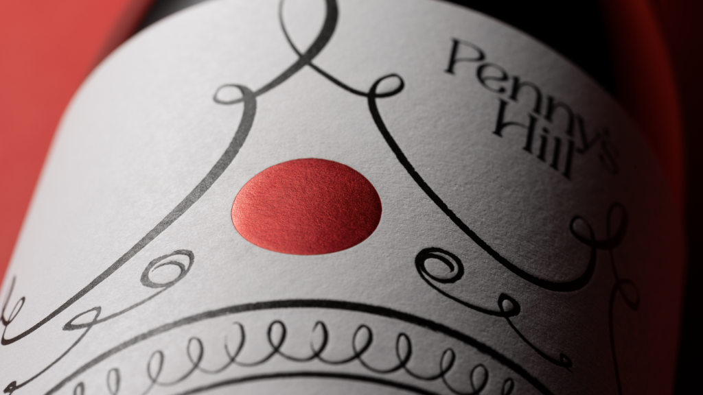 Close up detail of the front of pack, showing the grown illustrations on textured paper label with a foiled red dot forming the crown jewel.