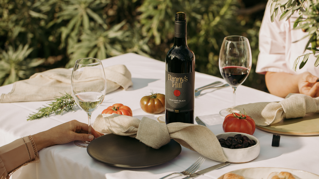 Lifestyle image of table setting, showing bottle of Cracking Black.