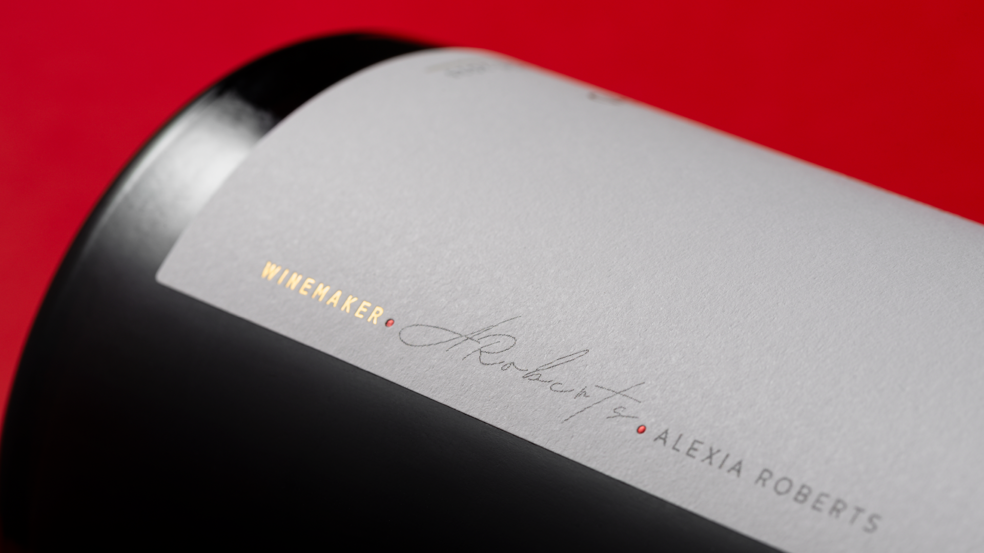 Detailed close up showing the winemakers signature on the side of the label design.