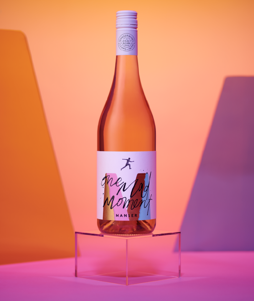 Single bottle of Manser Wines One Mad Moment rosé with bright warm label colours, expressive handwritten typography and foil detailing.